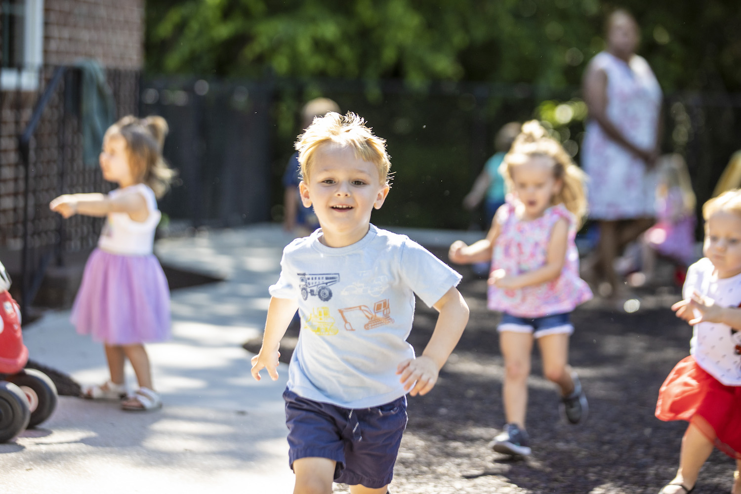 Boy running with other children in background